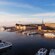 A marina full of boats near a palace